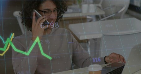 Holding smartphone to ear while typing on laptop in cafe co-working area, with data graph overlay