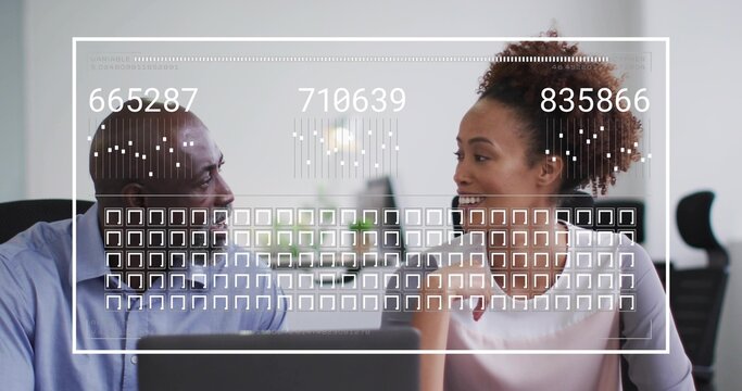 Analyzing colleagues in business attire discussing data at office desk with laptop, digital overlay