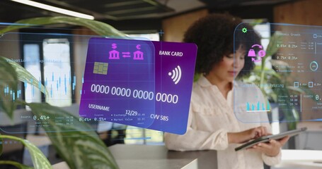 Using tablet businesswoman in blouse analyzing bank card and charts at office counter, copy space