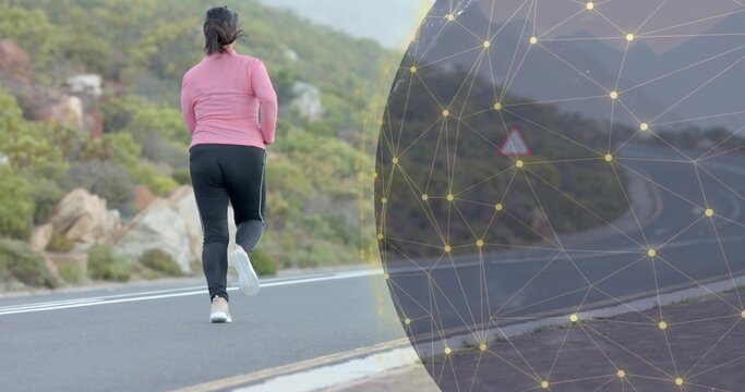 Jogging woman wearing pink top and black leggings on paved mountain road, with digital mesh overlay