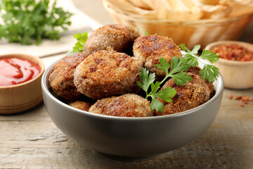 Tasty meat patties served on wooden table, closeup