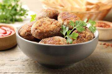 Tasty meat patties served on wooden table, closeup