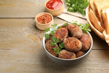 Tasty meat patties served on wooden table. Space for text