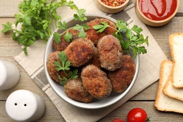 Tasty meat patties served on wooden table, flat lay