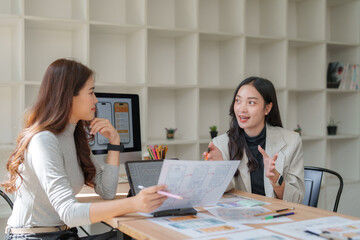 Asian women designers collaborating on user interface development