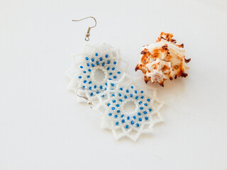 Bead white earrings on a white background