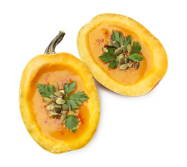 Tasty pumpkin cream soup with seeds and parsley isolated on white, above view