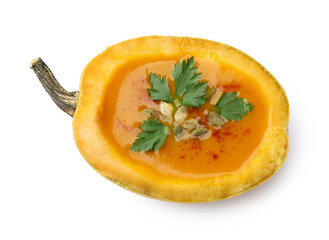 Tasty pumpkin cream soup with seeds and parsley isolated on white, top view
