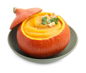 Tasty pumpkin cream soup with parsley and croutons served in pumpkin isolated on white