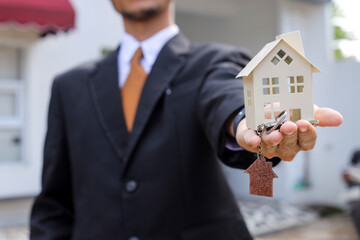 Modern Real Estate Agent Offers Keys to New Home for Sale