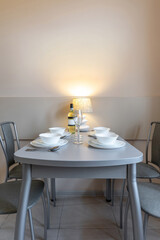 Cozy Minimalist Dining Table with Lamp and White Tableware