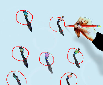 Hand drawing red circles around people for workforce selection concept