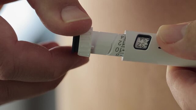 Turning dosage knob on injection pen to dial in proper medication dose