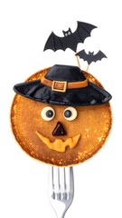 Halloween pancake decorated with face and bat toppers, held by fork