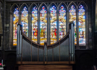 Metz, France - September 5, 2025: The modern organ and stained-glass windows in the south transept of Saint Stephen cathedral, achieved in 1552 and listed historical monument since 1930.