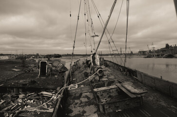sunken and broken ships in a destroyed port in Ukraine during the war