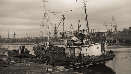 sunken and broken ships in a destroyed port in Ukraine during the war