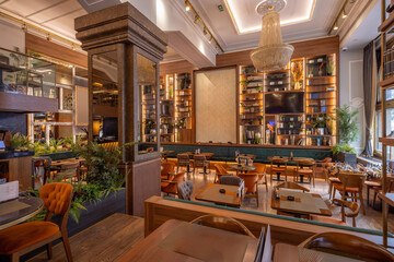 Restaurant interior featuring wooden furniture, soft lighting, and timeless design