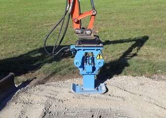 Hydraulic demolition hammer  attachment for excavator, during  roadwork at the roadside