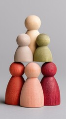 Arrangement Of Textured Wooden Figurines In A Pyramid Formation Showing Family Hierarchy And Connection Against A Neutral Gray Background Soft Studio Lighting