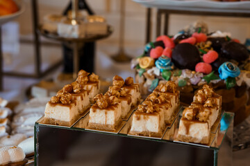 Elegant Dessert Table Display with Caramel Squares, Walnut Toppings, and Colorful Chocolate Treats Luxury Pastry Selection in Golden Hues