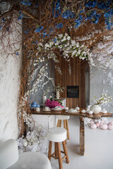 interior of a modern kitchen decorated with white flowers and pink pumpkins. Halloween conception 