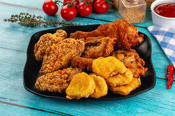 Golden crispy fried chicken mix - wings, drumsticks, nuggets and strips