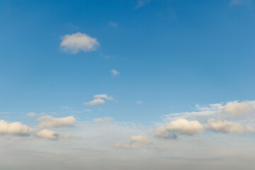Soft clouds floating in a bright blue sky