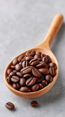 Fototapeta premium Close Up Of Dark Roasted Coffee Beans Filling A Rustic Wooden Spoon On A Textured Gray Surface With Natural Lighting