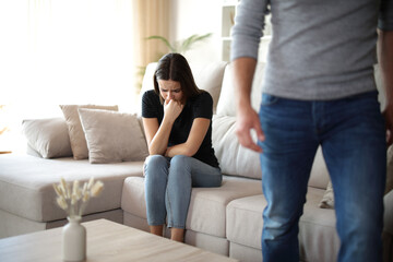 Boyfriend leaving his sad girlfriend at home