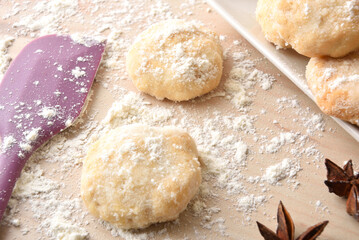 Macro of freshly made anise cookies on wooden bench elevated