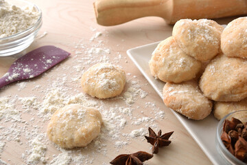 Detail of freshly made anise cookies on wooden bench