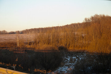 View from the window of a moving car on the countryside in winter