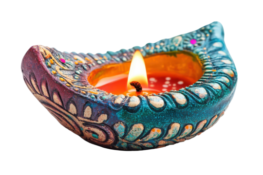 Ornate clay diya with burning flame isolated on transparent background. Diwali diya oil lamp isolated on white background.
