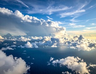 Aerial view of cumulus clouds over deep blue ocean, bright sunlight