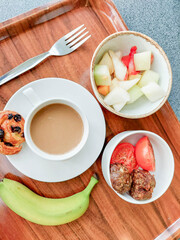 Breakfast with coffee, bun and meat patty, balanced breakfast on the pod