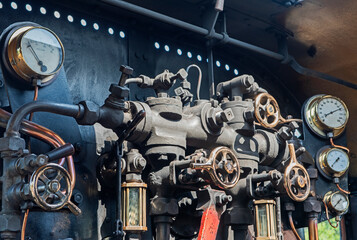 Valves and controls in engine of old heritage steam train