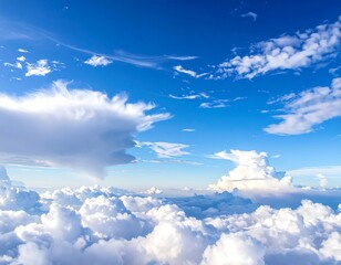 Aerial view of fluffy white clouds against a bright blue sky (1)