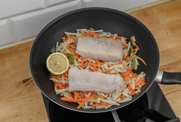 Atlantic cod loin prepared in a pan with vegetables