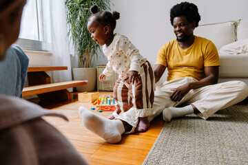 Father playing with young daughter