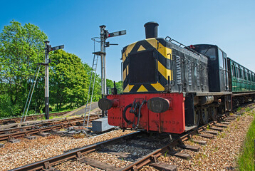 Old heritage diesel train on tracks in rural countryside setting