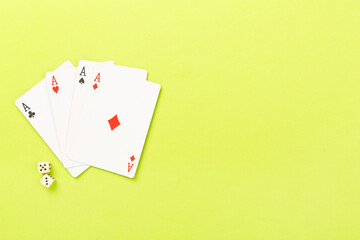 Poker chips and playing cards on color background, top view. Casino card game