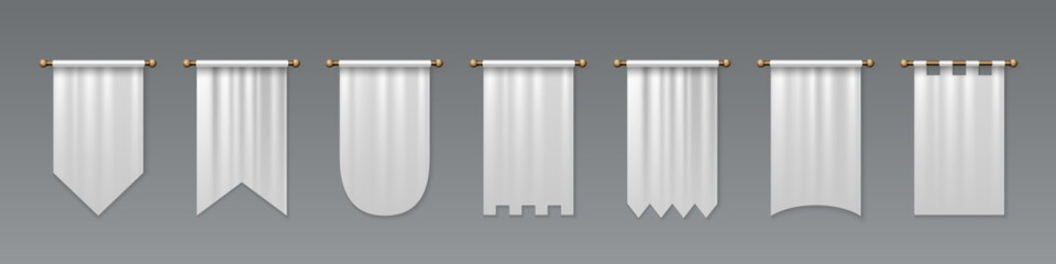 White medieval pennant set hanging on golden rods - pointed flag shapes, castle battlements, rounded bottoms and rectangular banners for heraldic display. Royal textile standards with decorative cuts. © klyaksun