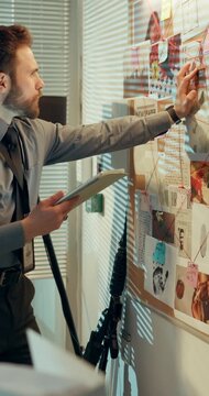 Investigation, board or man in office with tablet, cross reference or information in case review. Mind map, reading or detective at station with tech, connection and clue analysis for crime update.