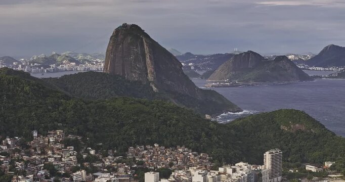 Rio de Janeiro Brazil Aerial v27 zoomed flyover Copacabana shoreline capturing Sugarloaf Mountain on a peninsula and Niteroi cityscape across the water - Shot with Mavic 3 Pro Cine - Mar 25th 2024