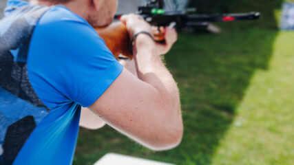 Crossbow shooting and archery at the shooting range, women and men practicing with arbalest at...