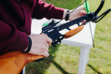 Crossbow shooting and archery at the shooting range, women and men practicing with arbalest at...