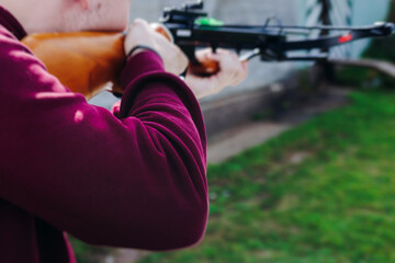 Crossbow shooting and archery at the shooting range, women and men practicing with arbalest at...