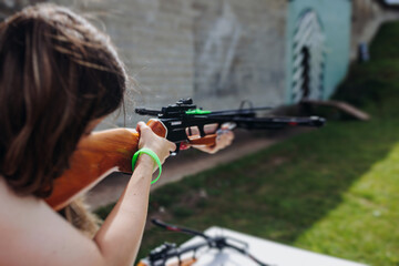 Crossbow shooting and archery at the shooting range, women and men practicing with arbalest at...
