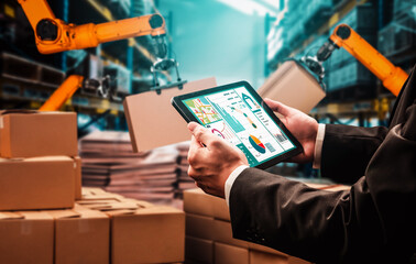 Smart robot arm systems for innovative warehouse and factory digital technology . Automation manufacturing robot controlled by industry engineering using IOT software connected to internet network .